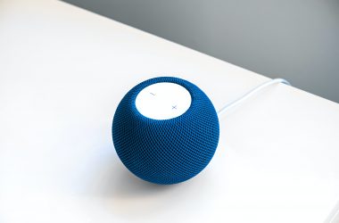 Image of a blue HomePod mini on a white table